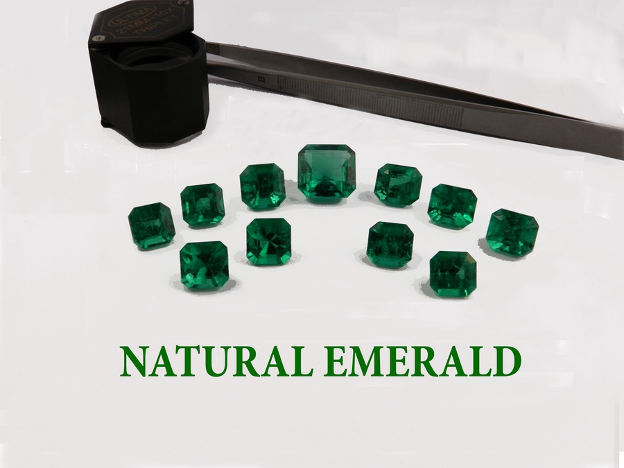 Multiple faceted emeralds and gem tools with the title 'NATURAL EMERALD'